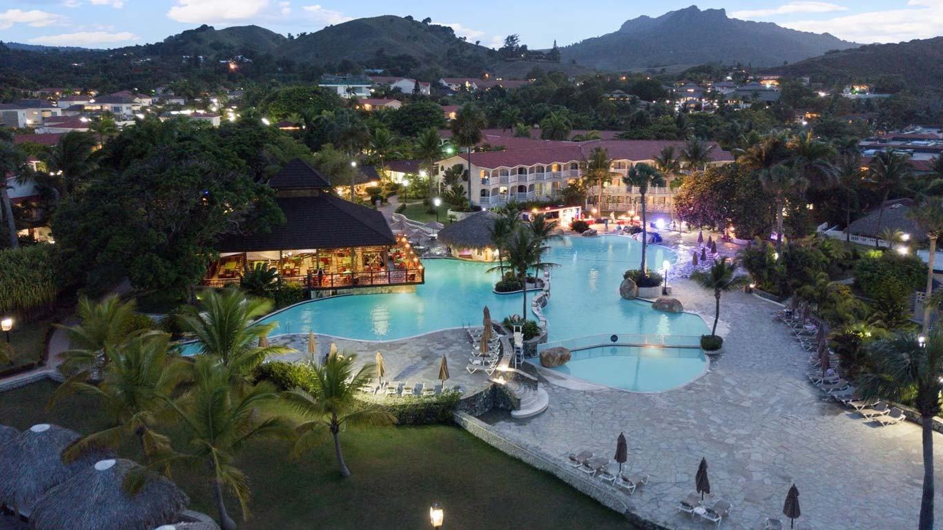 Illuminated resort pool at night at The Tropical