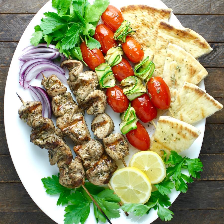 Mediterranean chicken kebabs served with vegetables and flatbread at Skewers